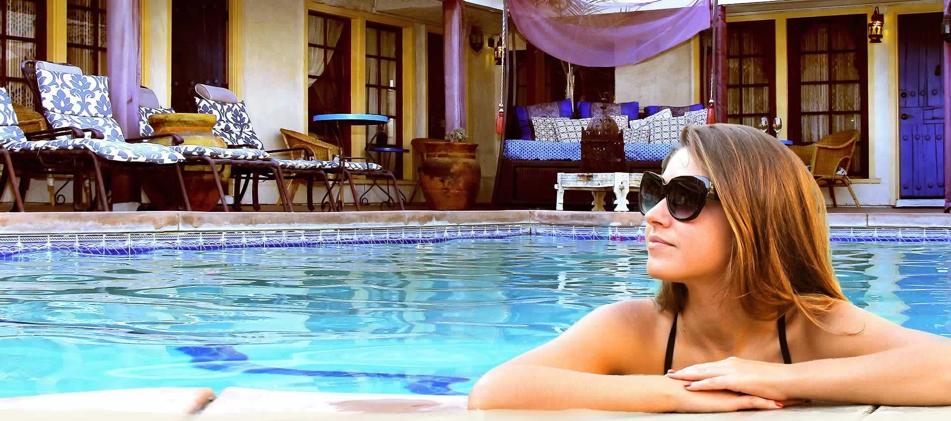 El Morocco Inn guest wearing sunglasses in pool