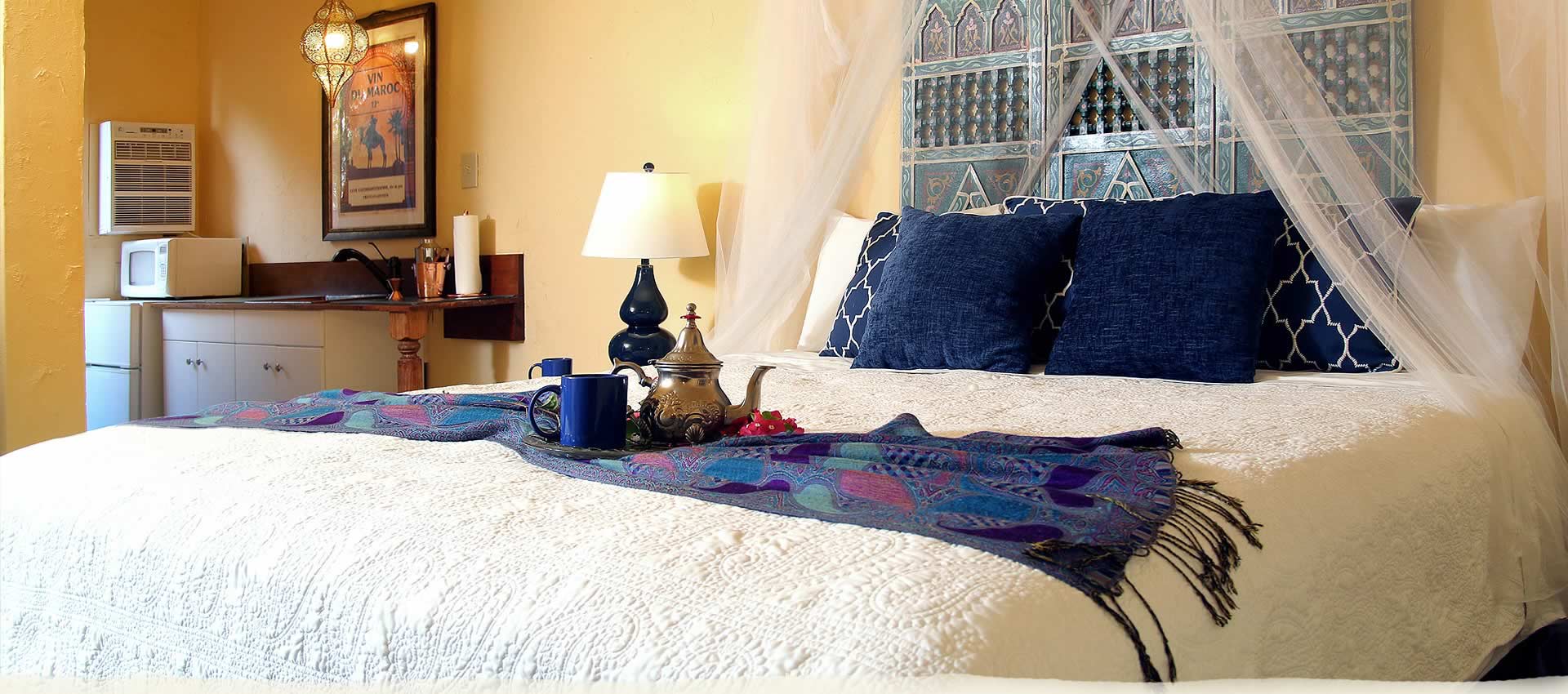 Private King Room bed with tea service and decorative pillows