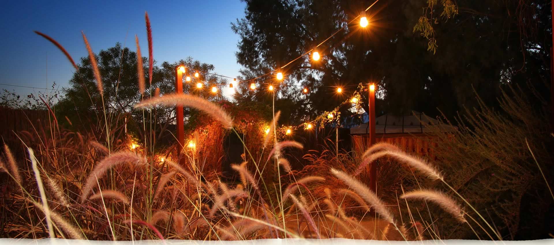 El Morocco Inn Garden at night with lights